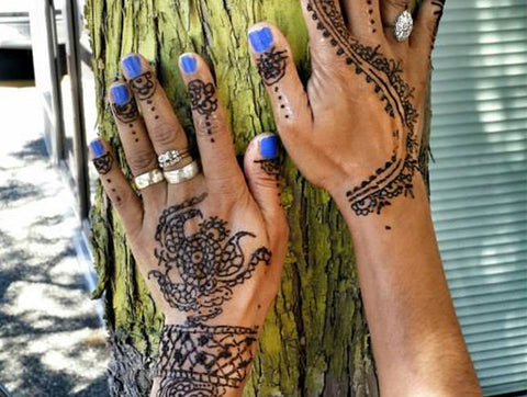 hands decorated with intricate henna art 